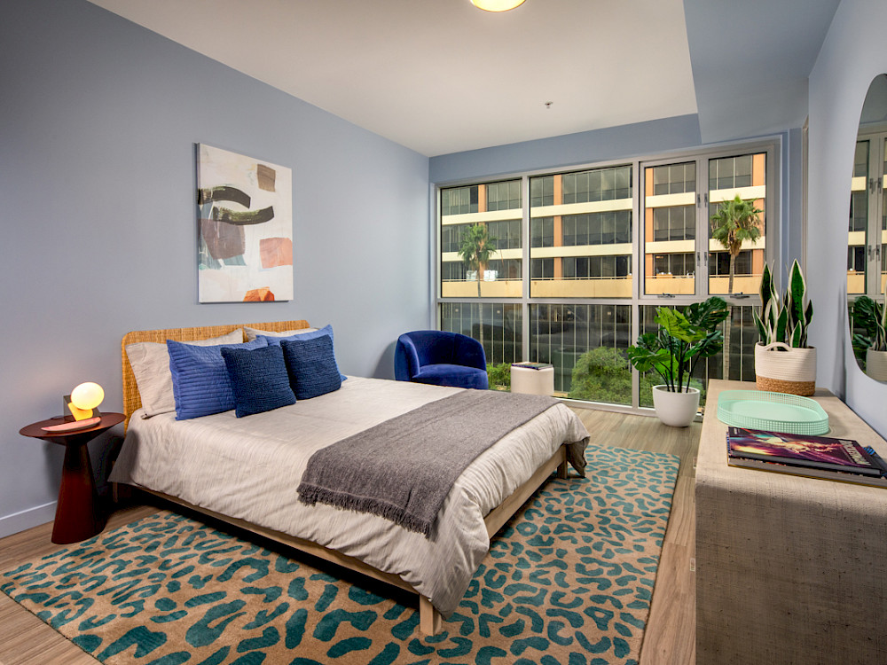 Two Bedroom Apartments in Westlake, CA - Wilco Master Bedroom with Floor-to-Ceiling Window, Wood-Style Flooring, and Spacious Layout